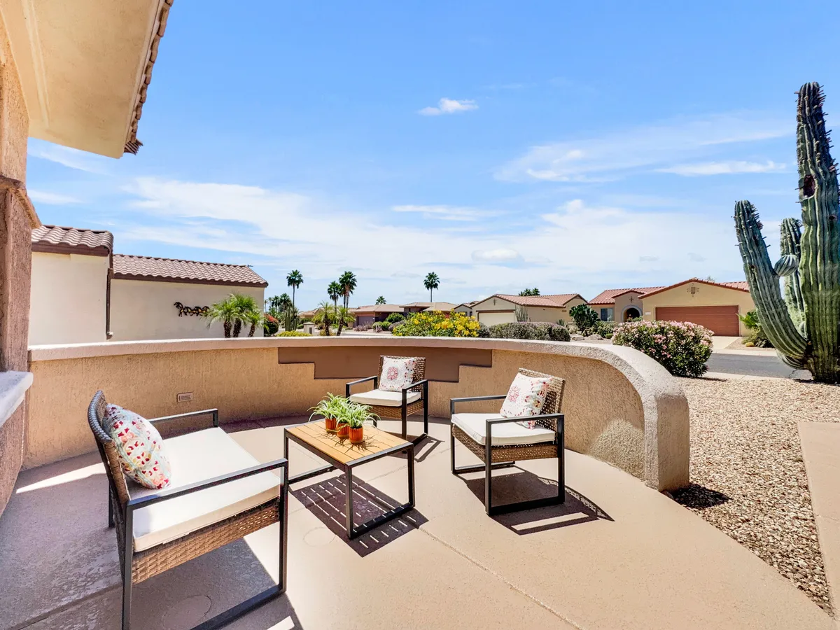 Set on a tranquil patio, this outdoor seating area features comfortable chairs, cactus and potted plants, and a view of the neighborhood. The space is perfect for reading, sipping wine, or enjoying the Arizona sunset in peace.